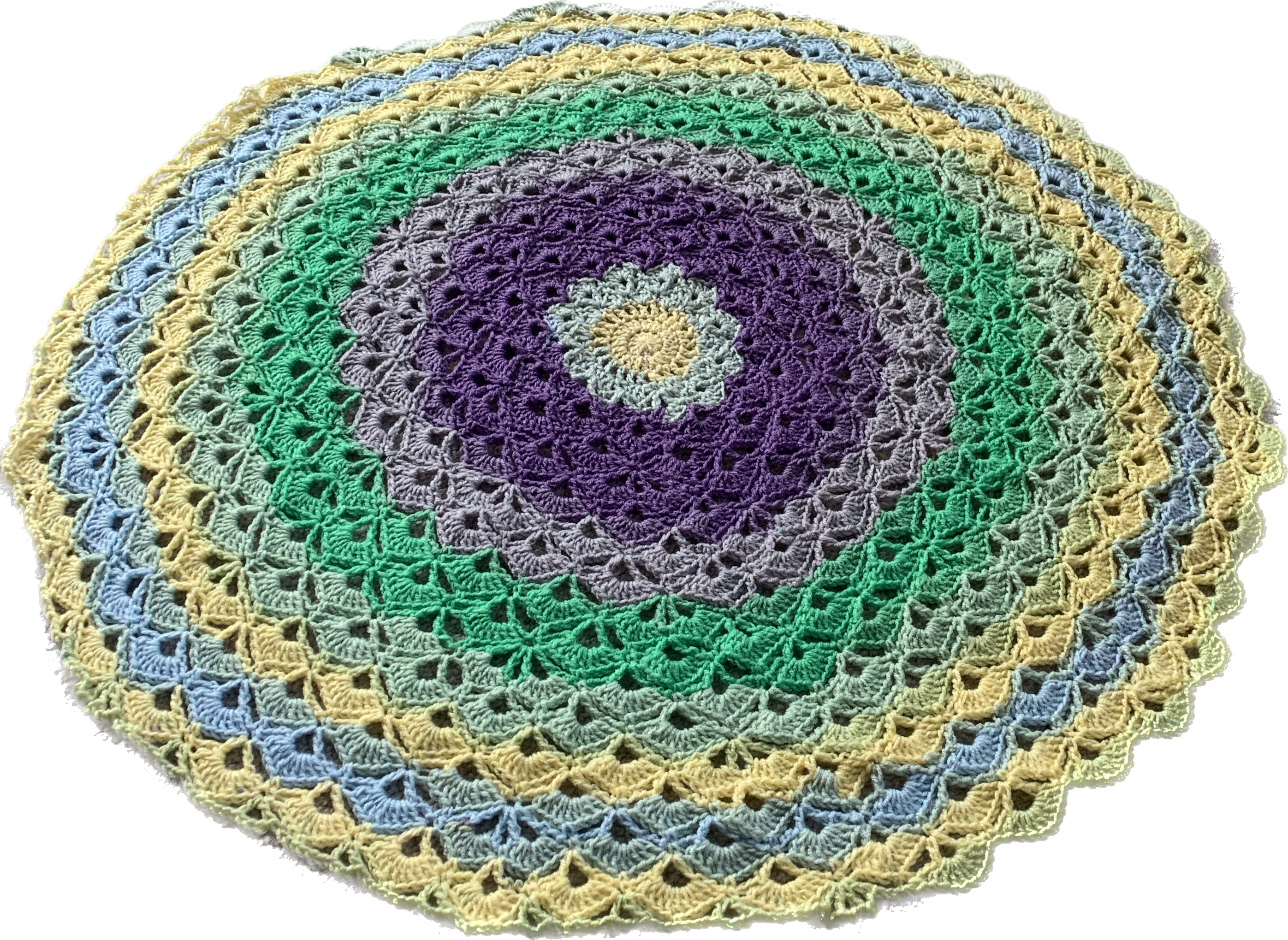 a round, pastel, crochet blanket filled with shell-like stitches