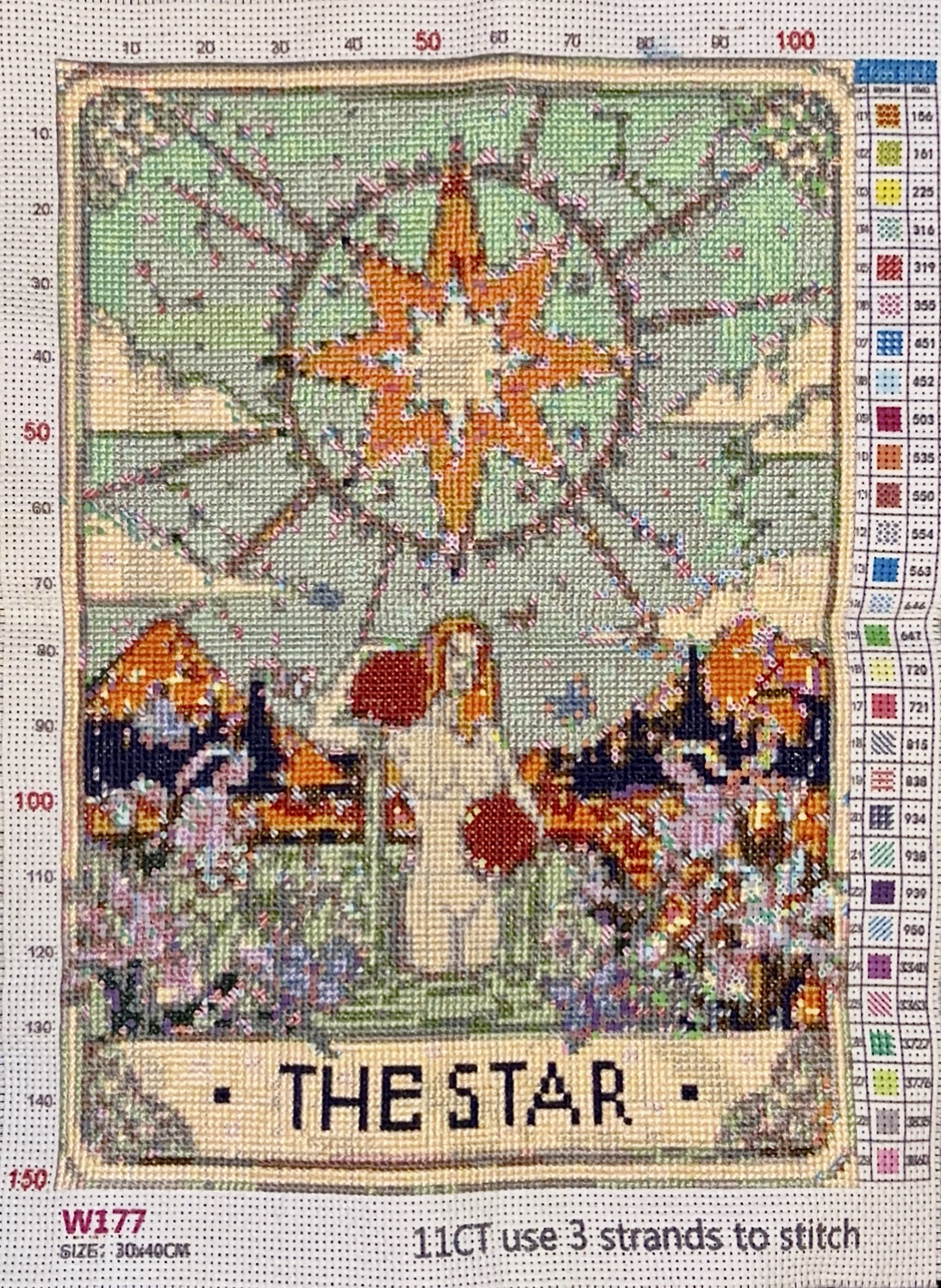 the frontside of a tarot-themed cross stitch pattern of The Star